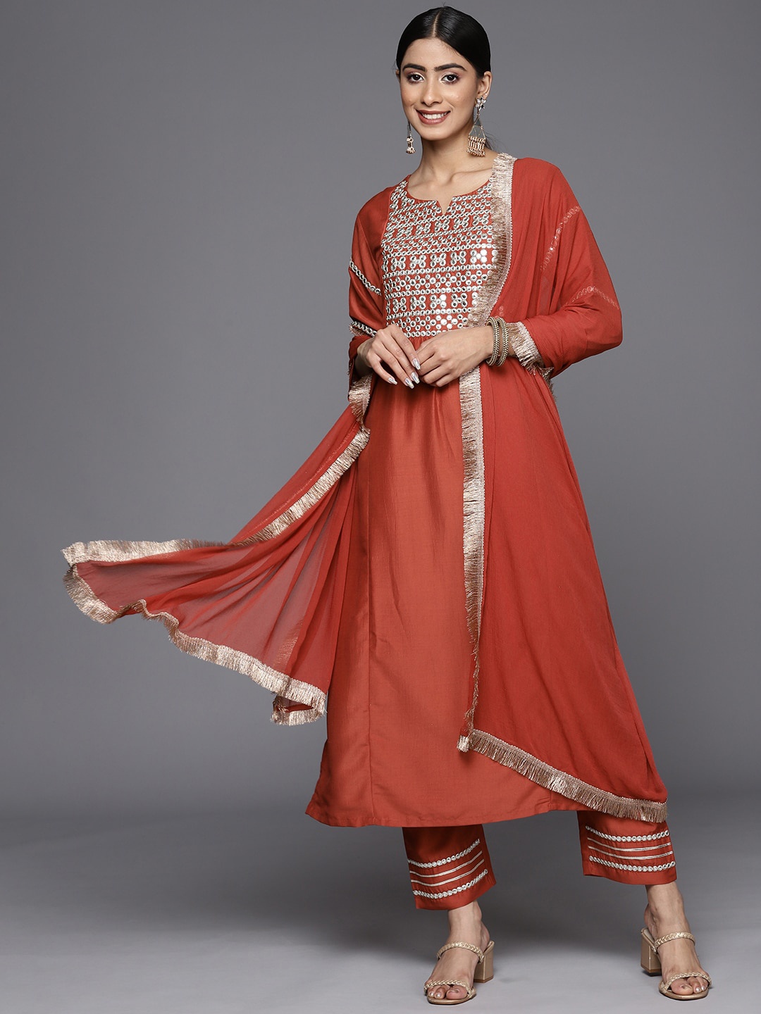 

KALINI Yoke Design Round Neck Mirror Work Kurta With Trousers & Dupatta, Rust