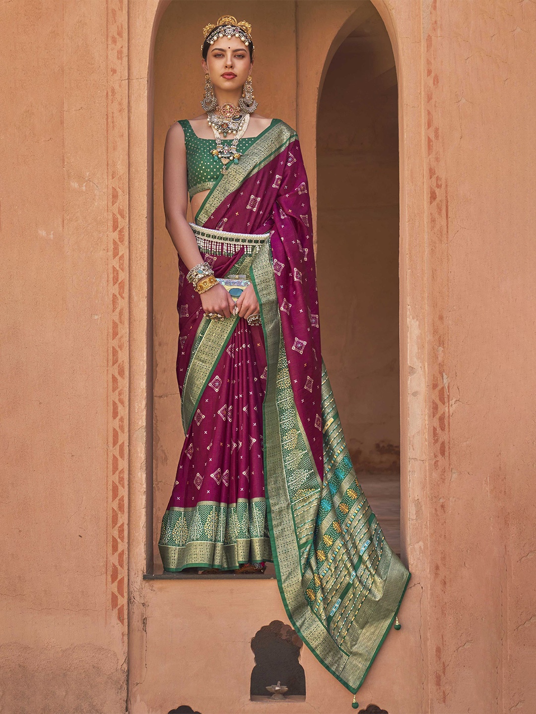

Mitera Magenta & Green Ethnic Motifs Zari Patola Saree