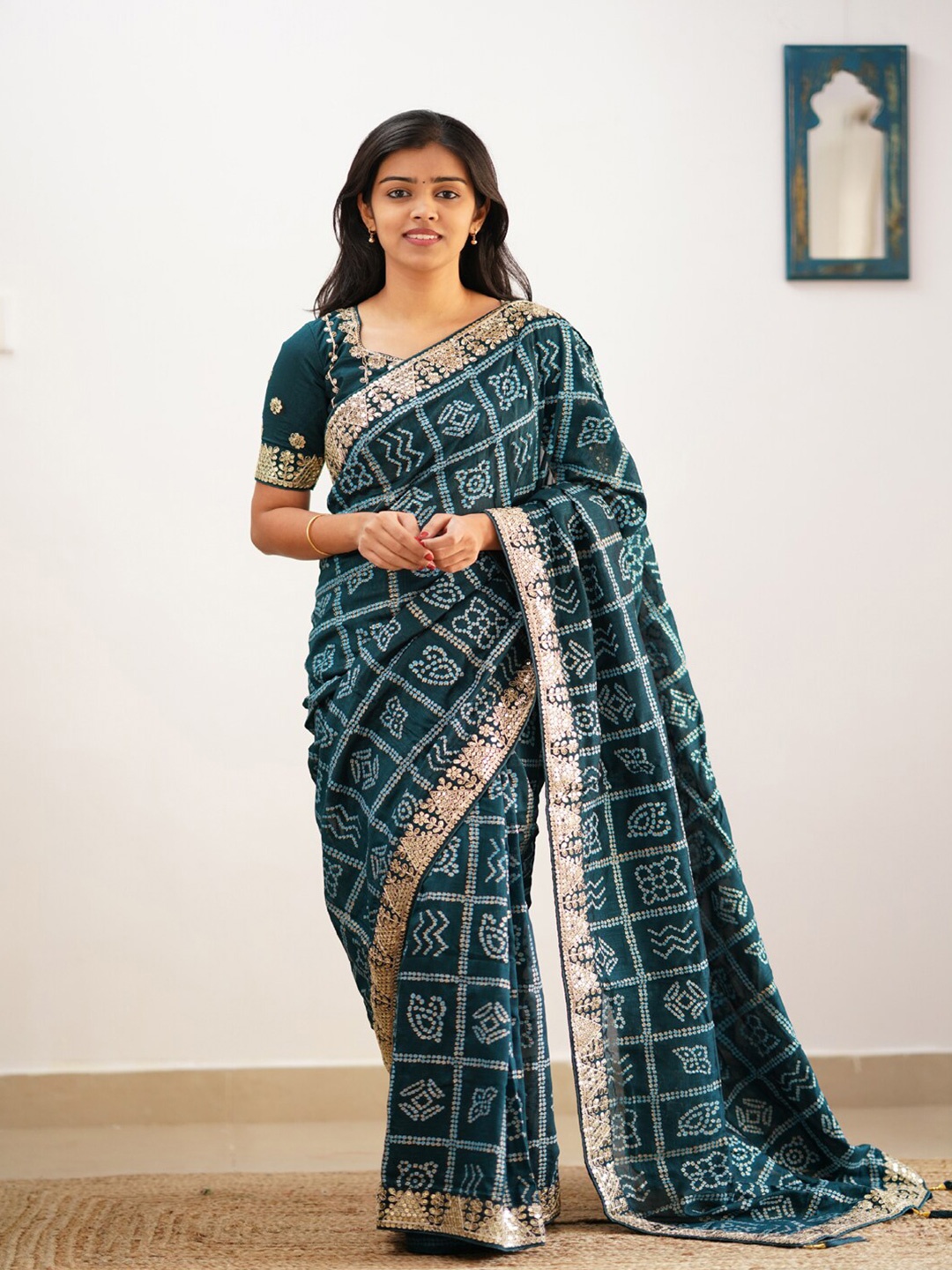 

Mitera Teal & White Bandhani Printed Embroidered Saree