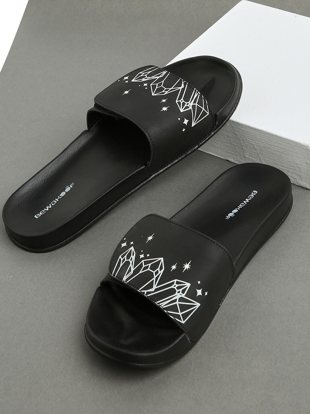 

Bewakoof Women Black Mystic Crystals Printed Rubber Sliders