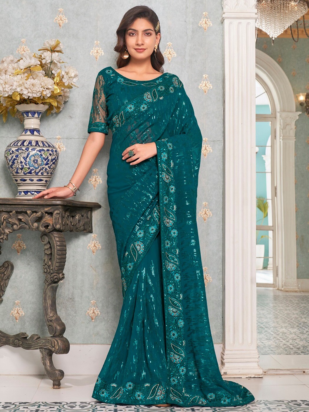 

Mitera Teal Embellished Sequinned Pure Georgette Heavy Work Saree