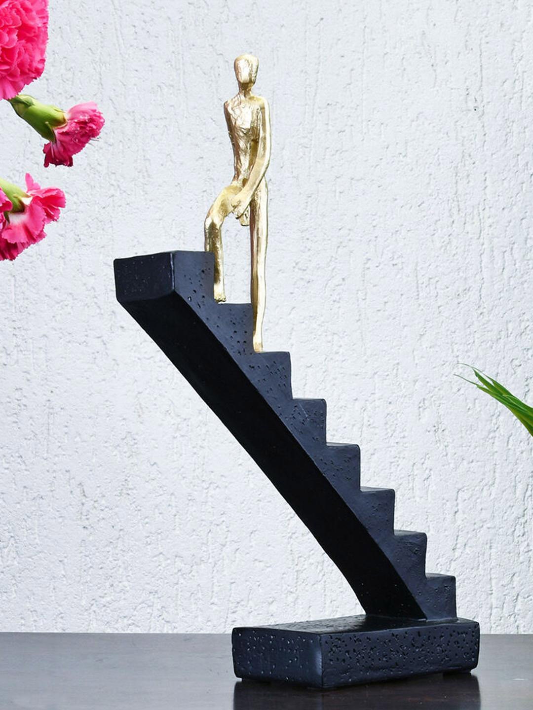 

Athome by Nilkamal Black & Gold Toned Climbing Stairs Showpiece