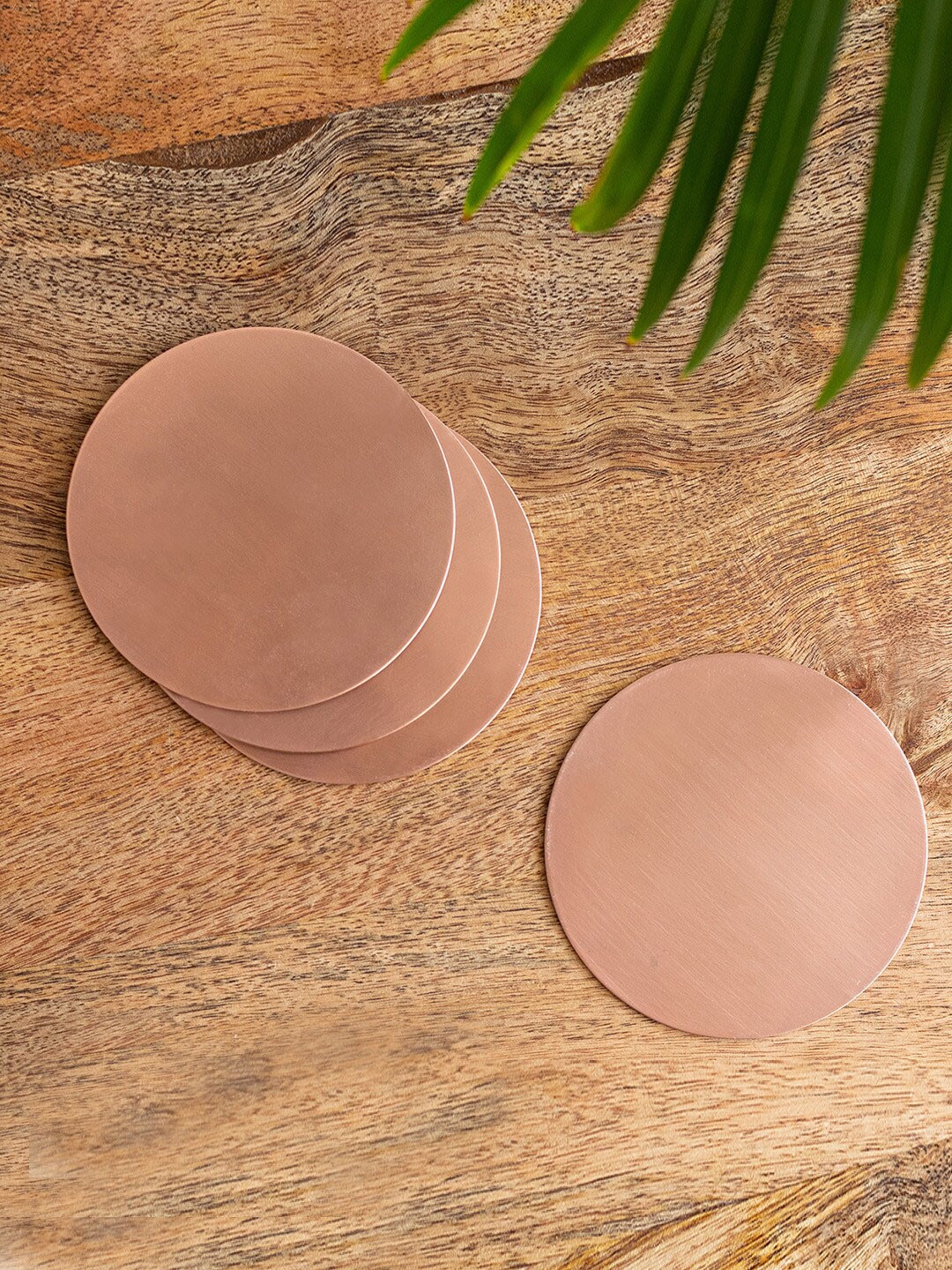 

ExclusiveLane Rose Gold Toned 4 pieces Sleek Minimalism Painted Round Iron Coasters