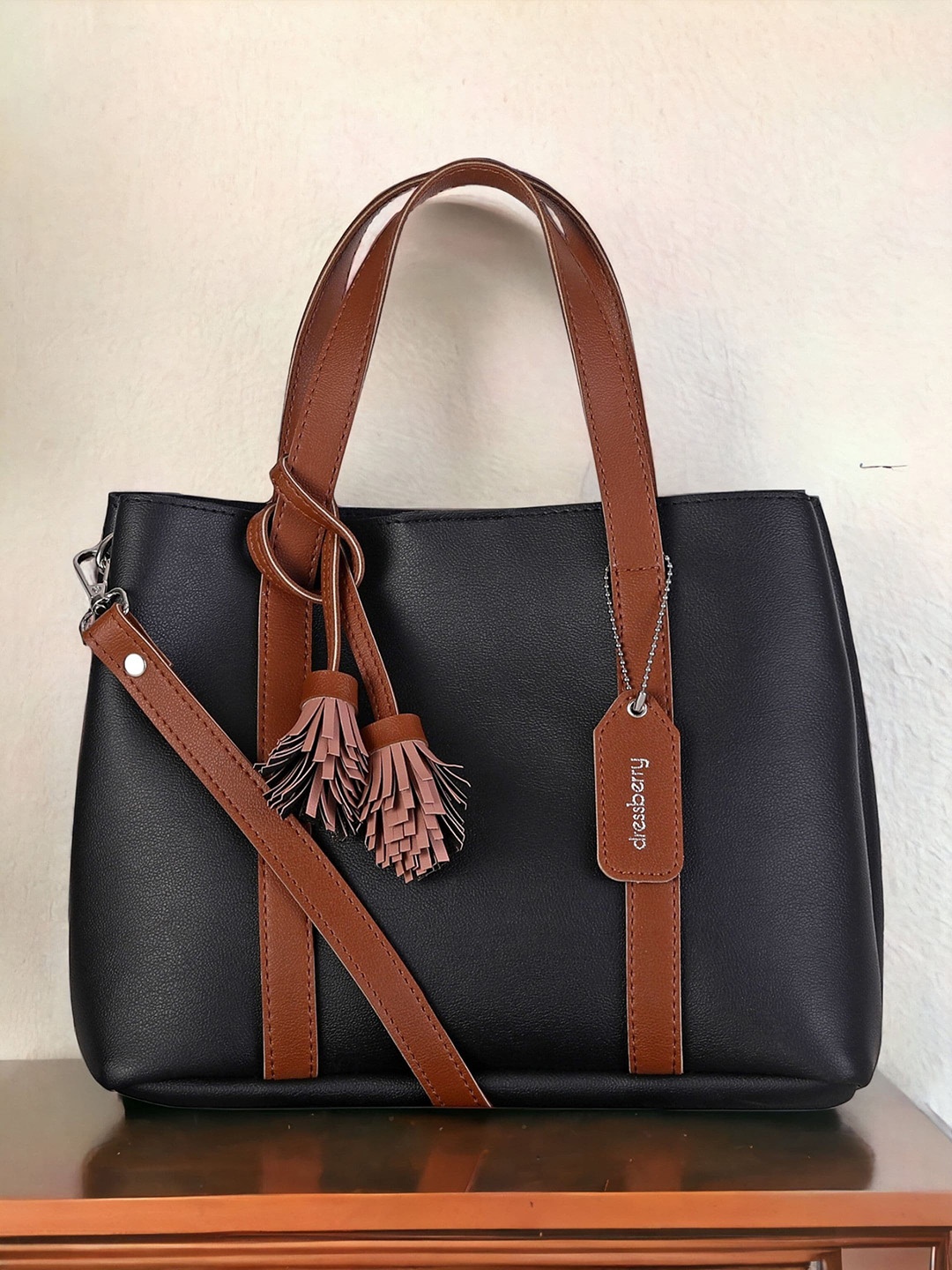 

DressBerry Black Textured Structured Handheld Bag with Tasselled