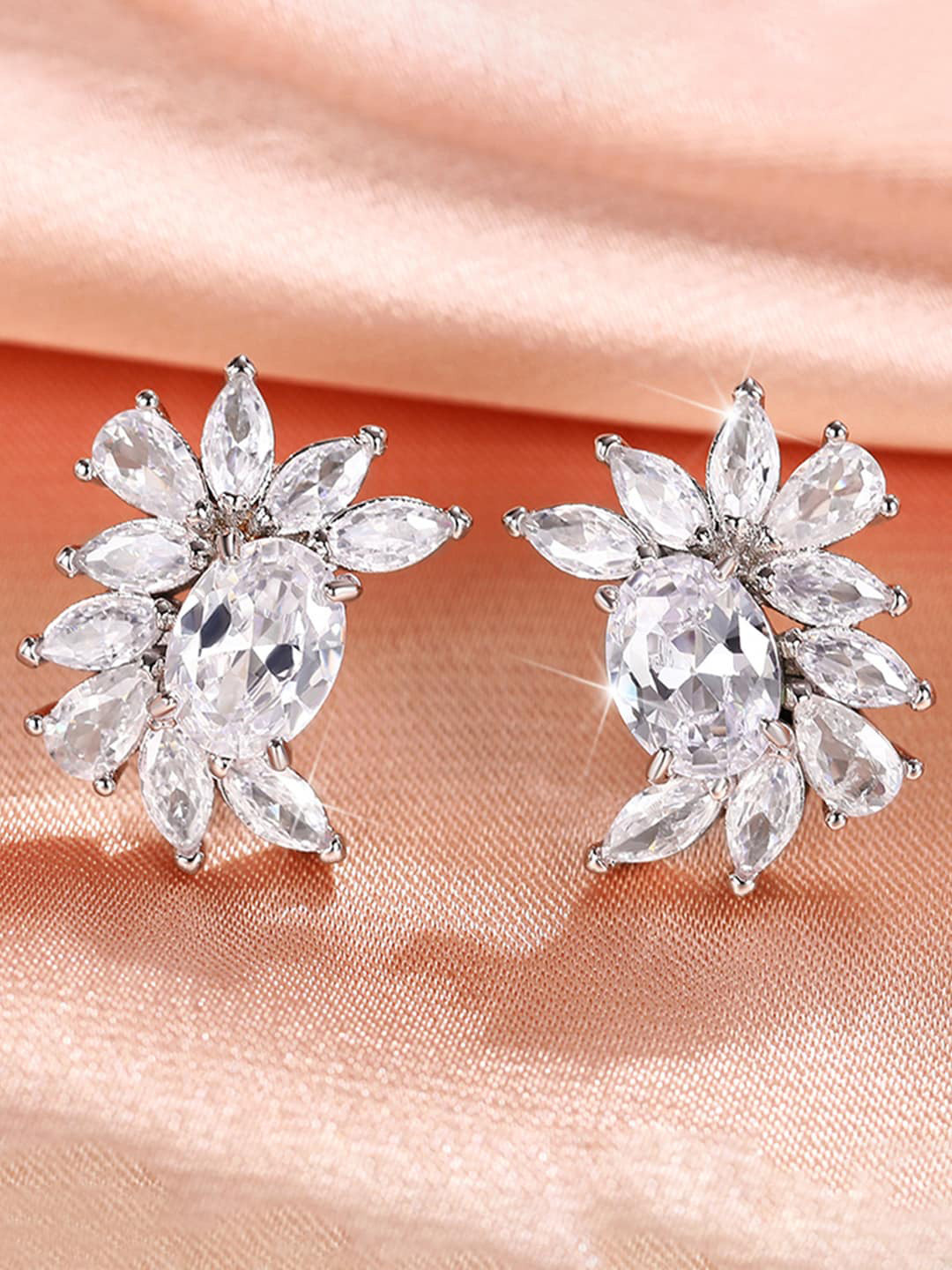 

Jewels Galaxy Silver-Plated American Diamond Studded Contemporary Studs Earrings