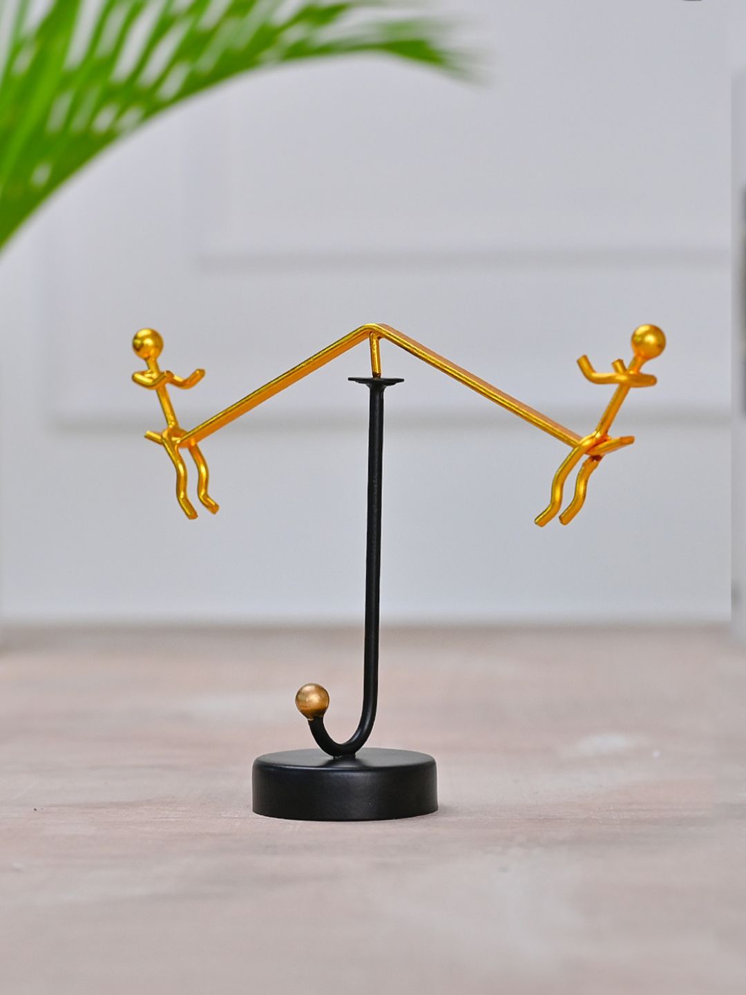 

DecorTwist Gold-Toned Perpetual Motion Toy Showpiece