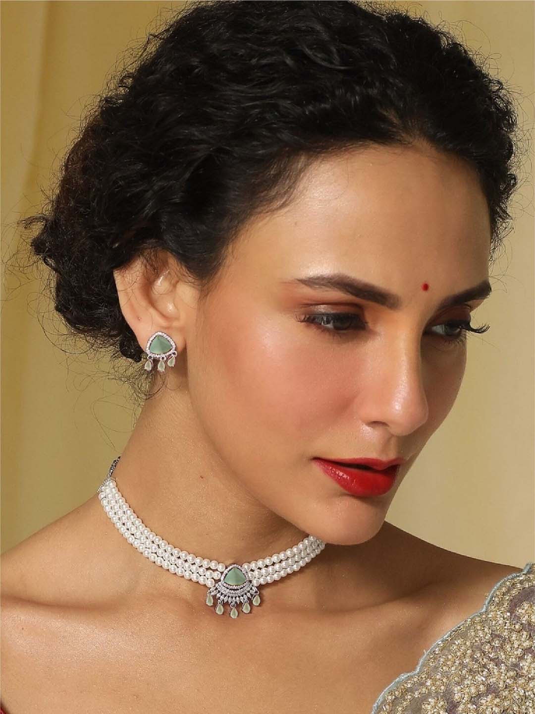 

Tarinika Bella Nakshatra Gold-Plated CZ-Studded Pearl Beaded Choker Jewellery Set