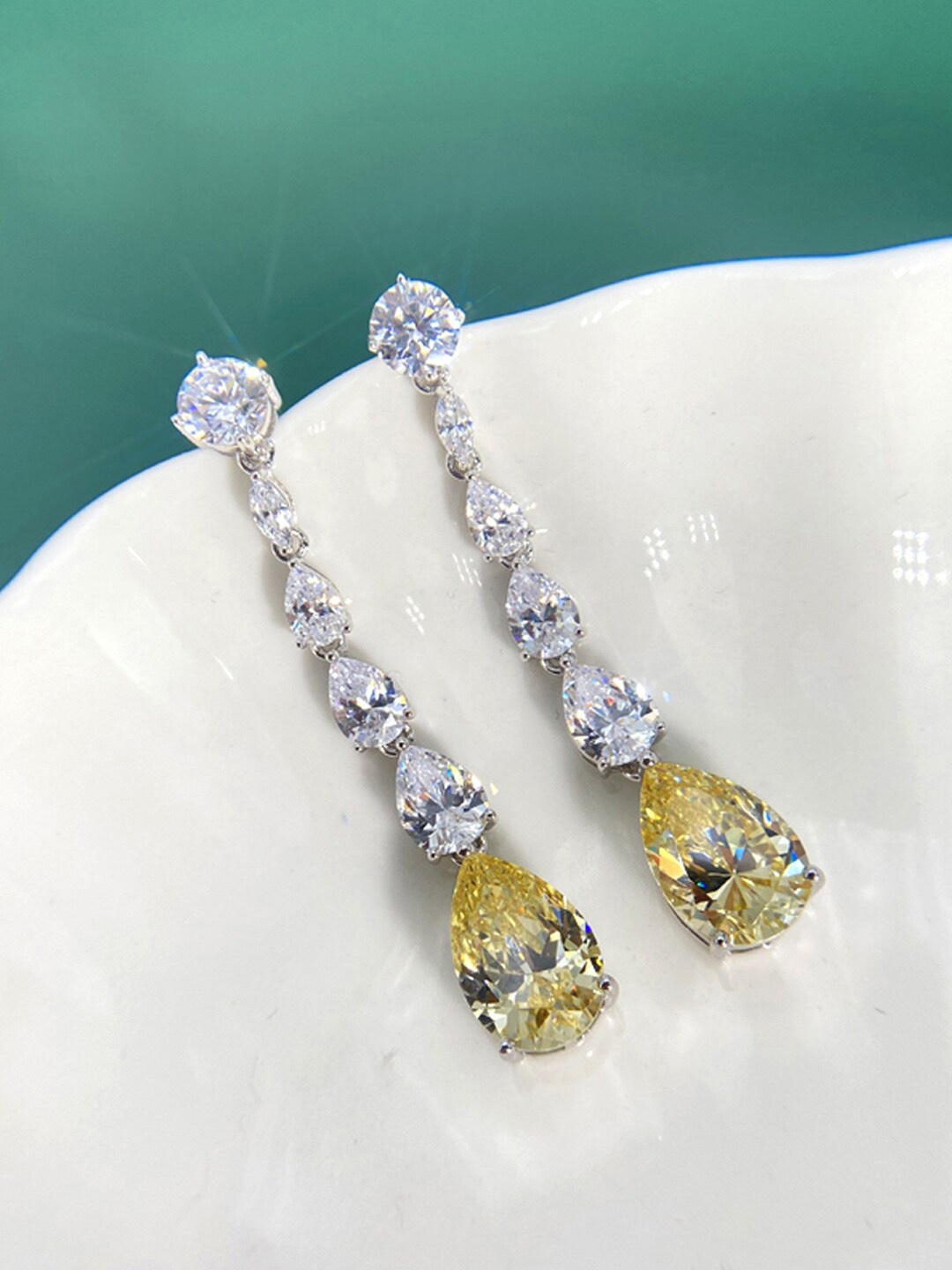 

Designs & You Silver-Plated Teardrop Shaped Drop Earrings