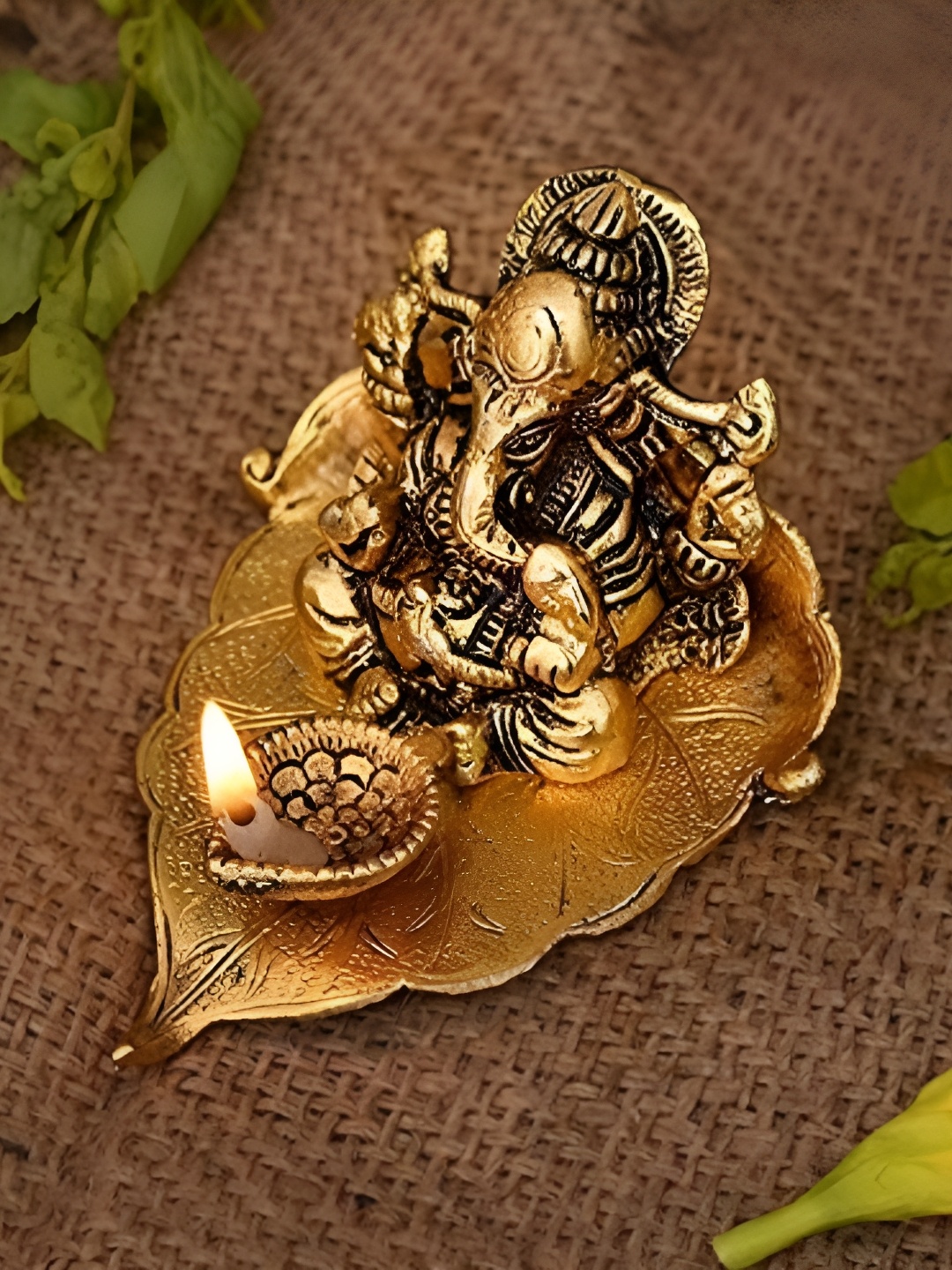 

HOME AUZAR Metal Toned Ganesh Ji On Leaf With Diya Religious Idol Showpiece, Metallic