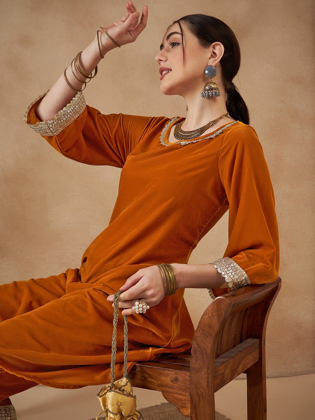 

Sangria Round Neck Flared Sleeves A-Line Velvet Kurta With Trousers, Mustard
