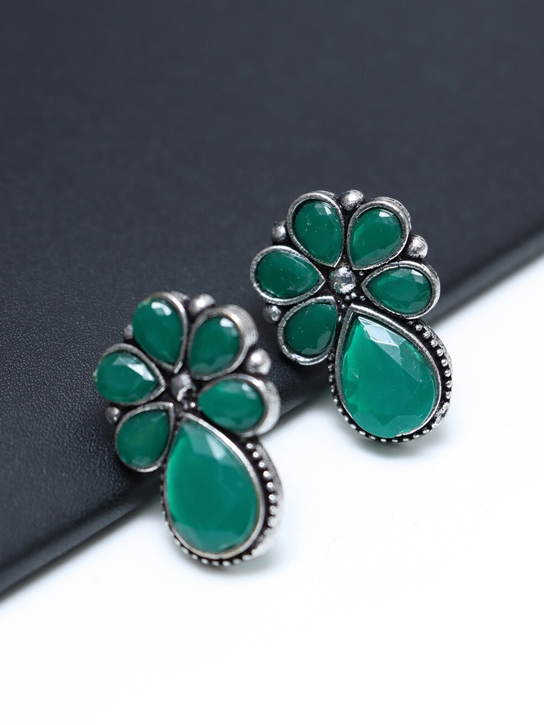 

Ozanoo Oxidised Silver Plated Stone Studded Floral Studs Earrings