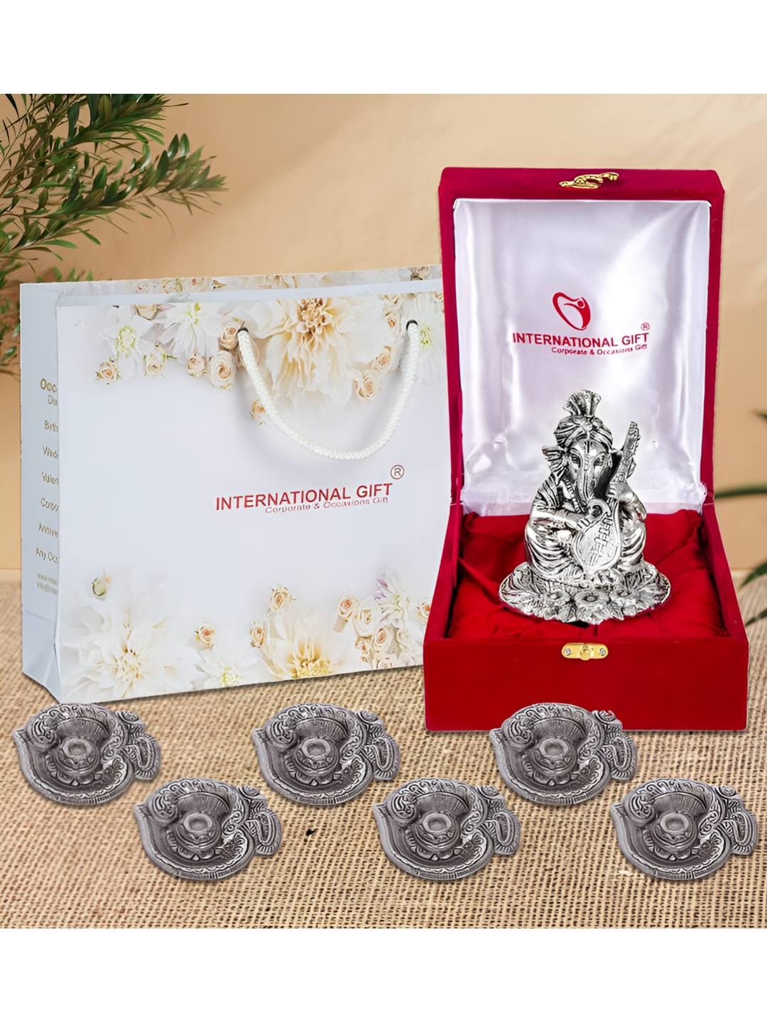 

INTERNATIONAL GIFT Silver Ganesha Idol & 6 Pieces Diyas Gift Set