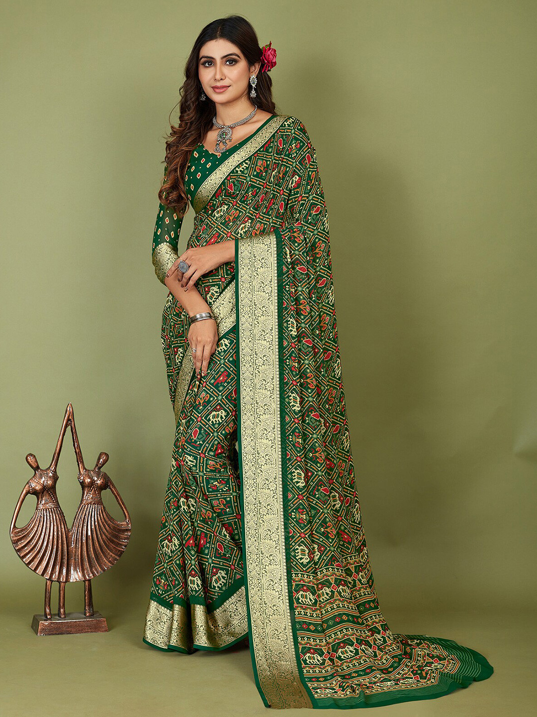 

Mitera Green Ethnic Motifs Printed Silk Cotton Patola Saree