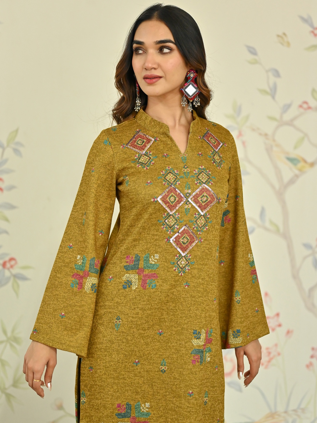 

Rustorange Phulkari Printed Mandarin Collar Bell Sleeves Sequins A-Line Woollen Kurta, Mustard