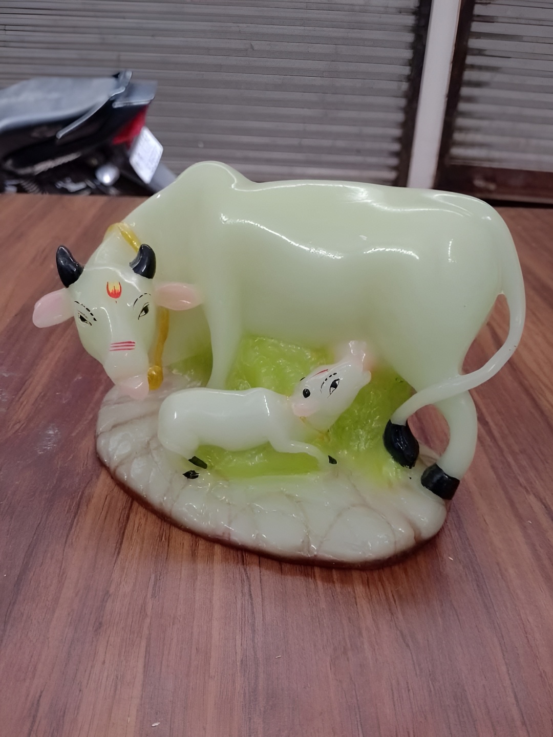 

VAMIKA HANDICRAFTS White & Green Cow Figurine Showpiece