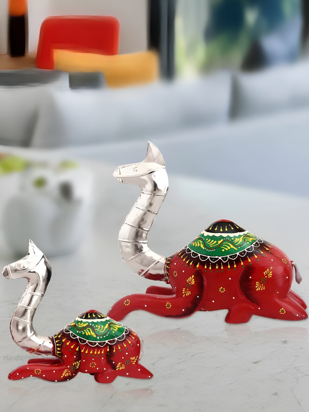 

HANDICRAFTS PARADISE Silver Toned 2 Pieces Seated Camel Figurine Showpiece