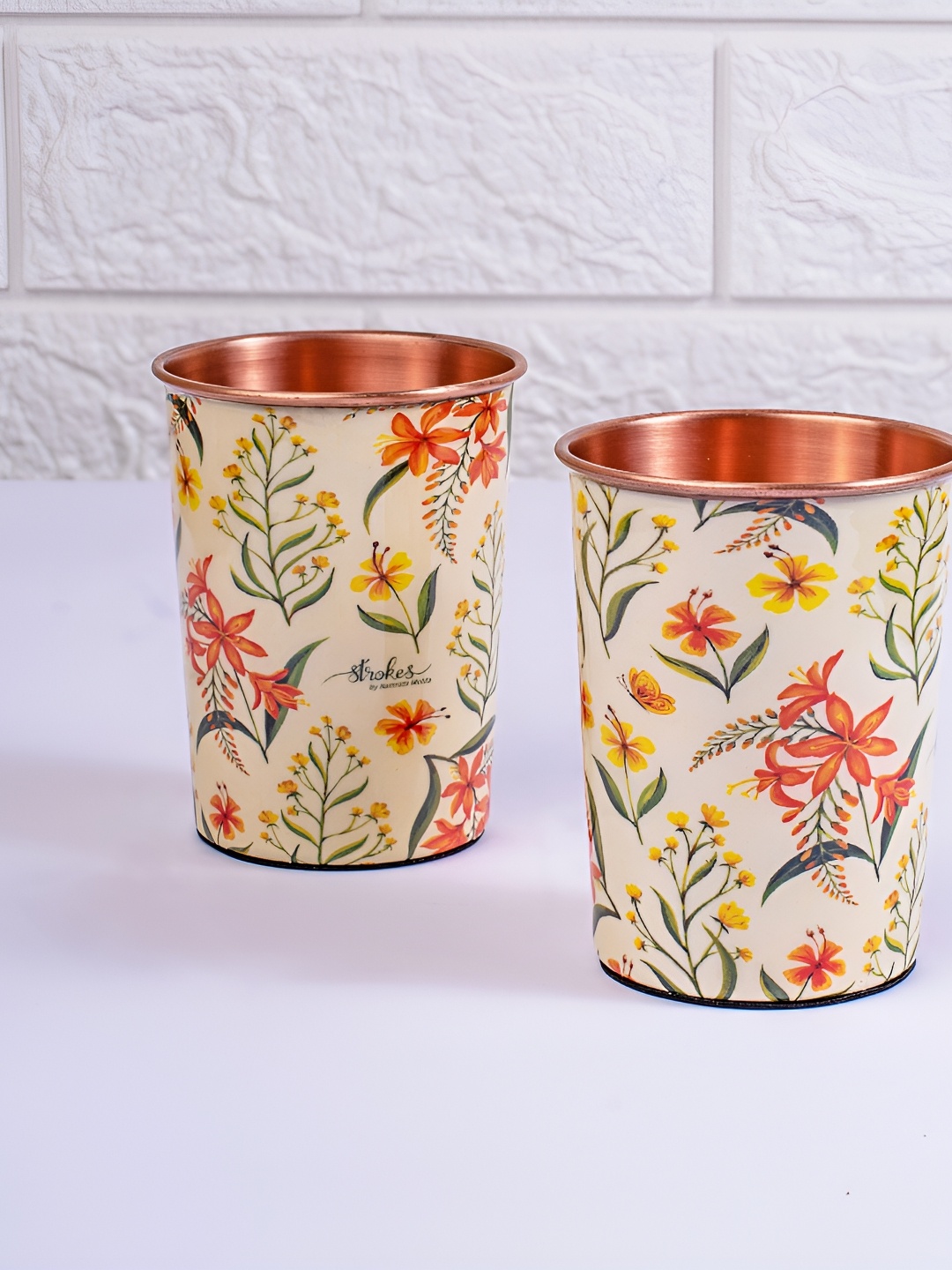 

Strokes by Namrata Mehta Off White & Orange 2 Pieces Floral Printed Copper Tumbler 200 ml