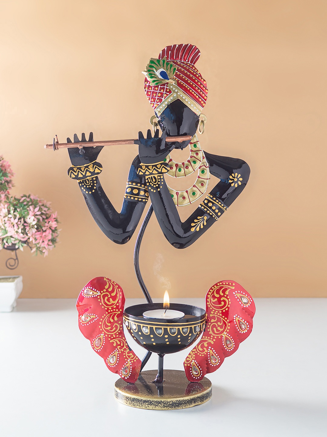 

Golden Peacock Red & Black Lord Krishna Candle Holder Cum Showpiece