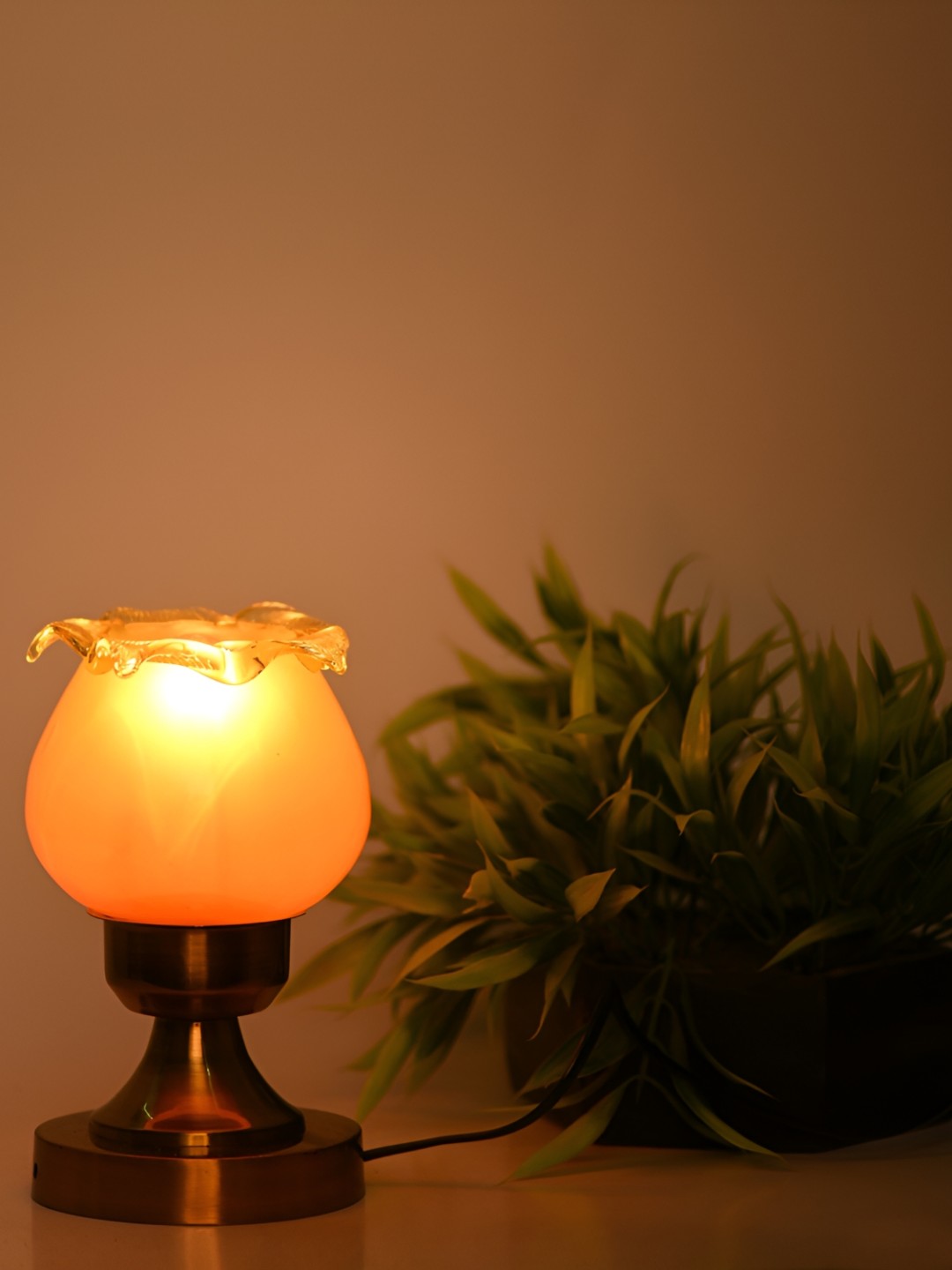 

Afast Gold Toned & Orange Spherical Shaped Glass Table Lamp with Adjustable Cord