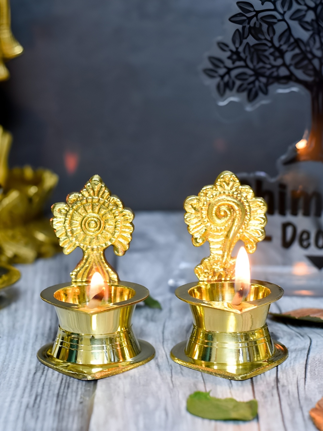 

Bhimonee Decor Gold Toned 2 Pcs Pure Brass Shanku Chakra Kamakshi Diya Pooja Essentials