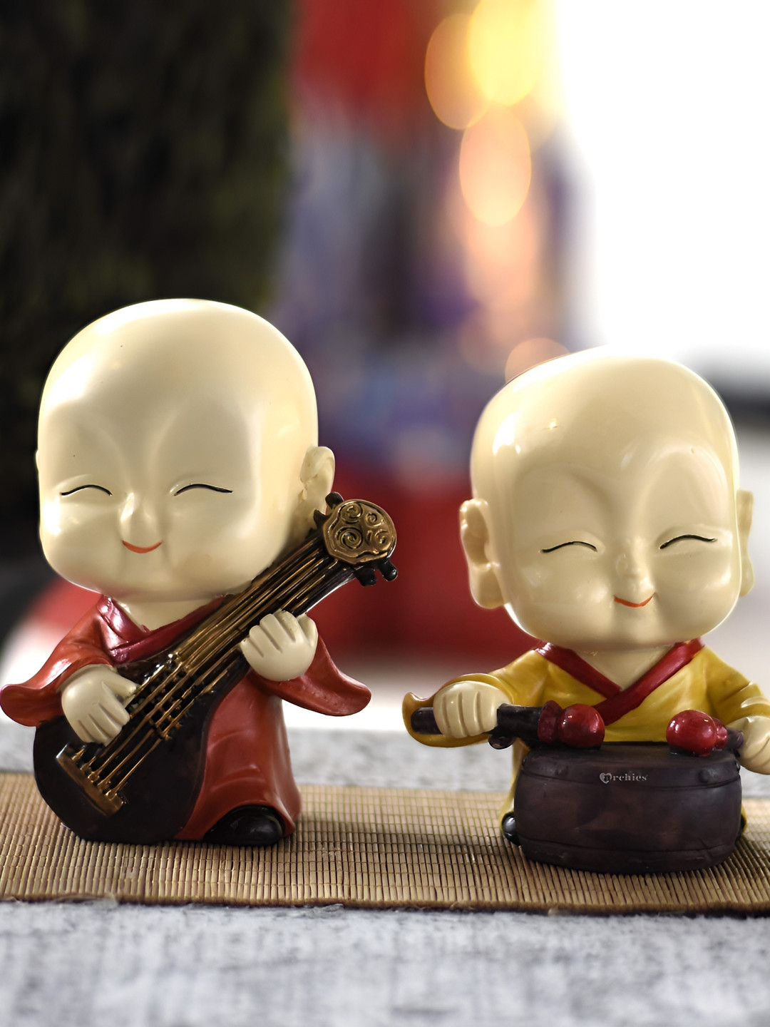 

SANKALAN CREATIONS Red & Yellow 2 Pieces Musical Buddha Figurine Showpiece