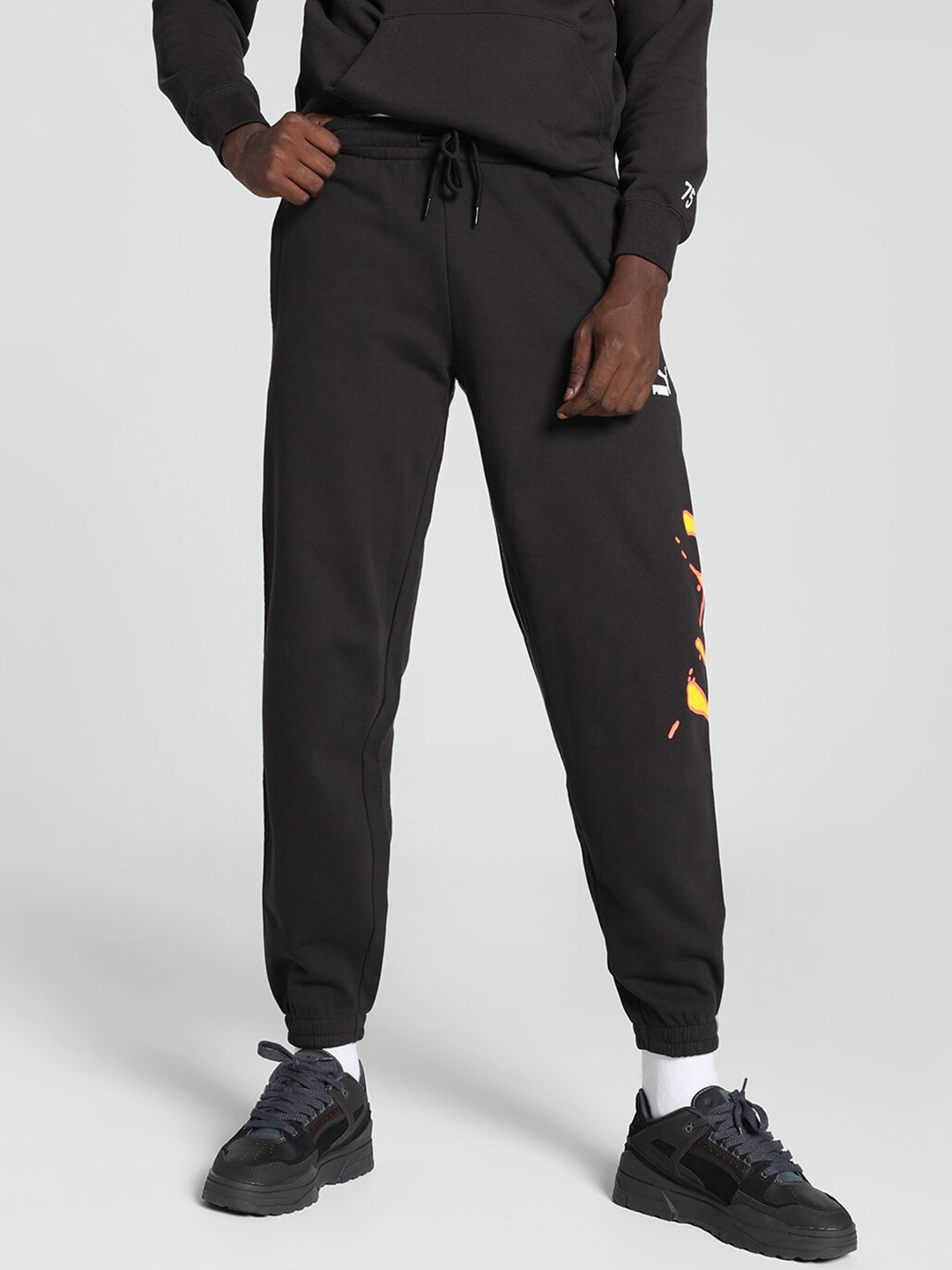 

Puma Sportswear Worldwide Men Mid-Rise Cotton Sweatpants Joggers, Black