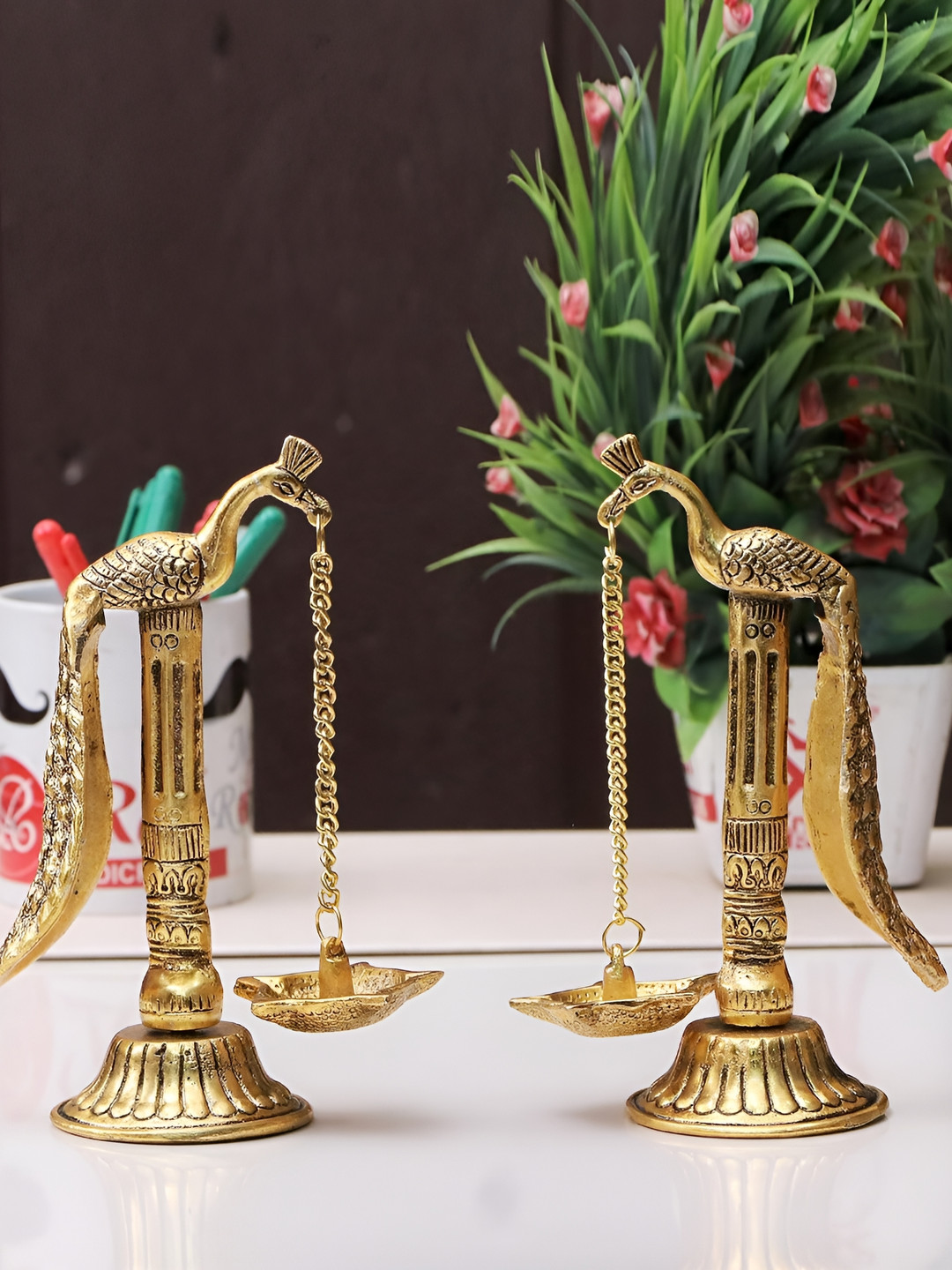 

Kridaykraft Gold-Toned 2 Pieces Peacock Design Metal Hanging Chain with Diya Showpiece