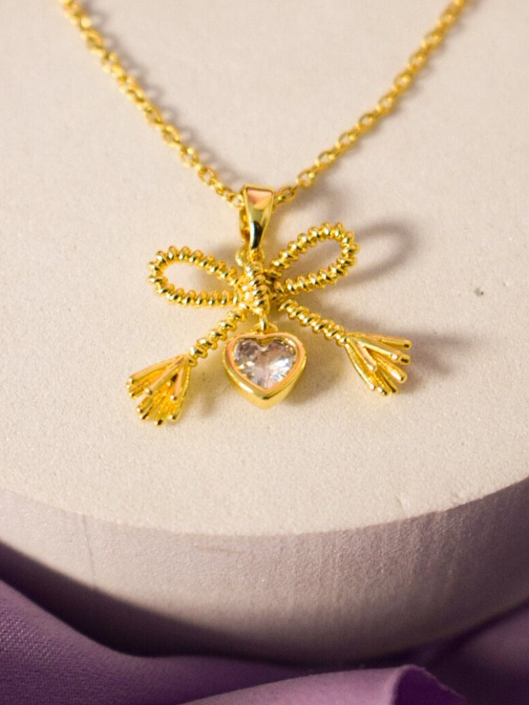 

DressBerry Gold Toned Bow Shaped Pendants with Chains