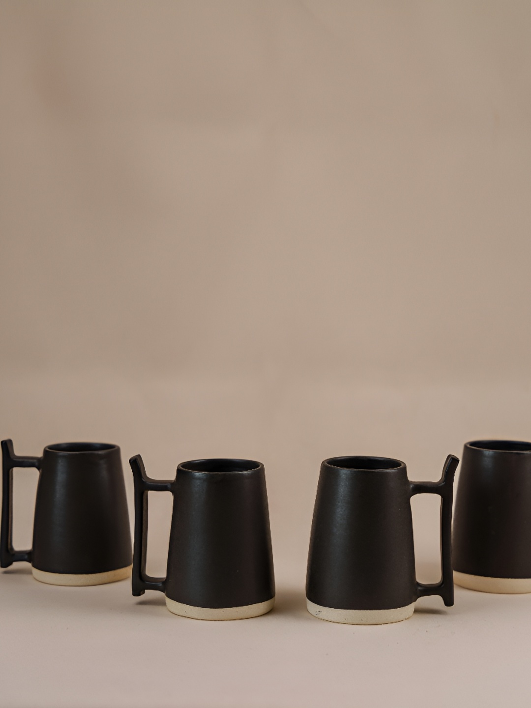 

The Orby House Black Beige 4 Pieces Ceramic Matte Finished Beer Mugs