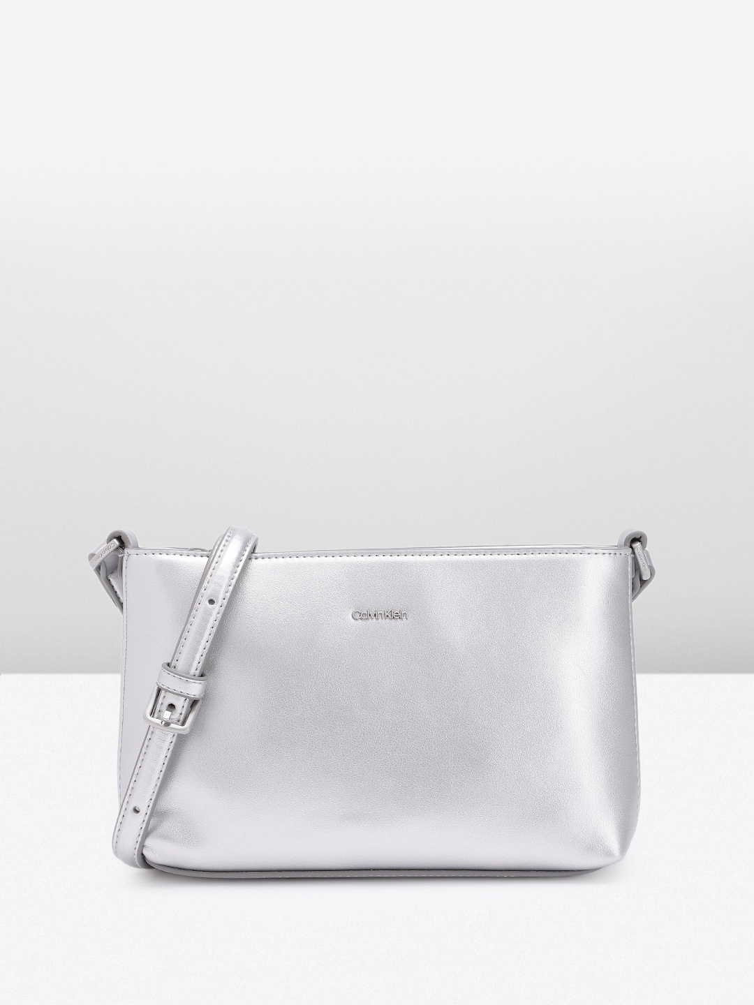 

Calvin Klein Women Solid Sling Bag, Silver