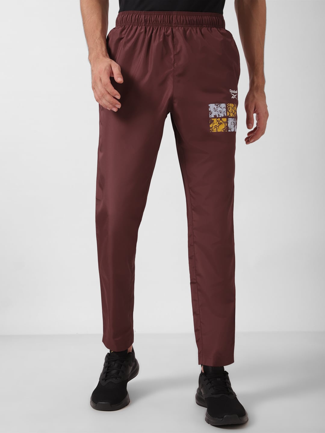 

Reebok Men Typography Printed Mid-Rise Track Pants, Maroon