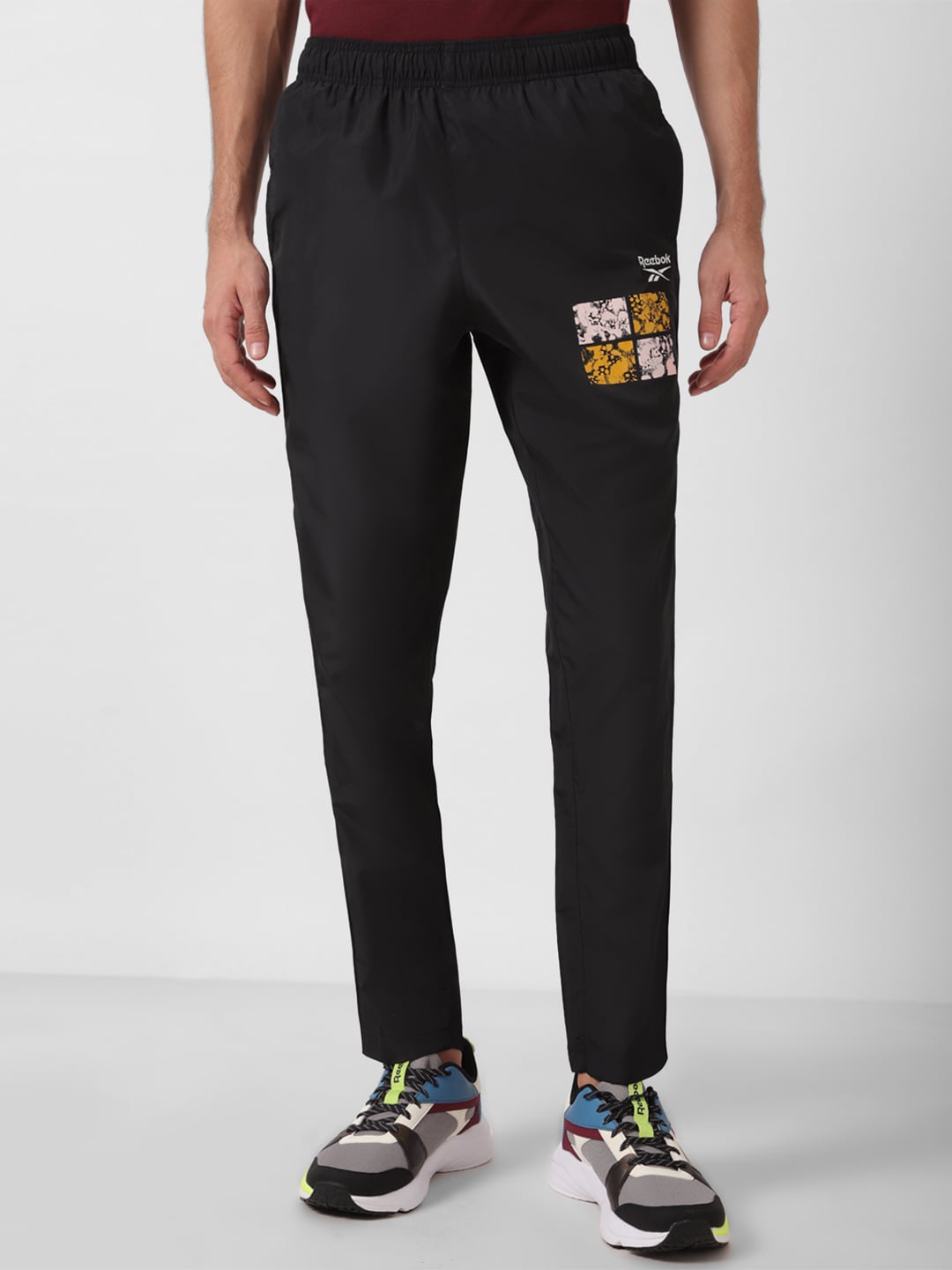 

Reebok Men Printed Training App Mid-Rise Track Pants, Black