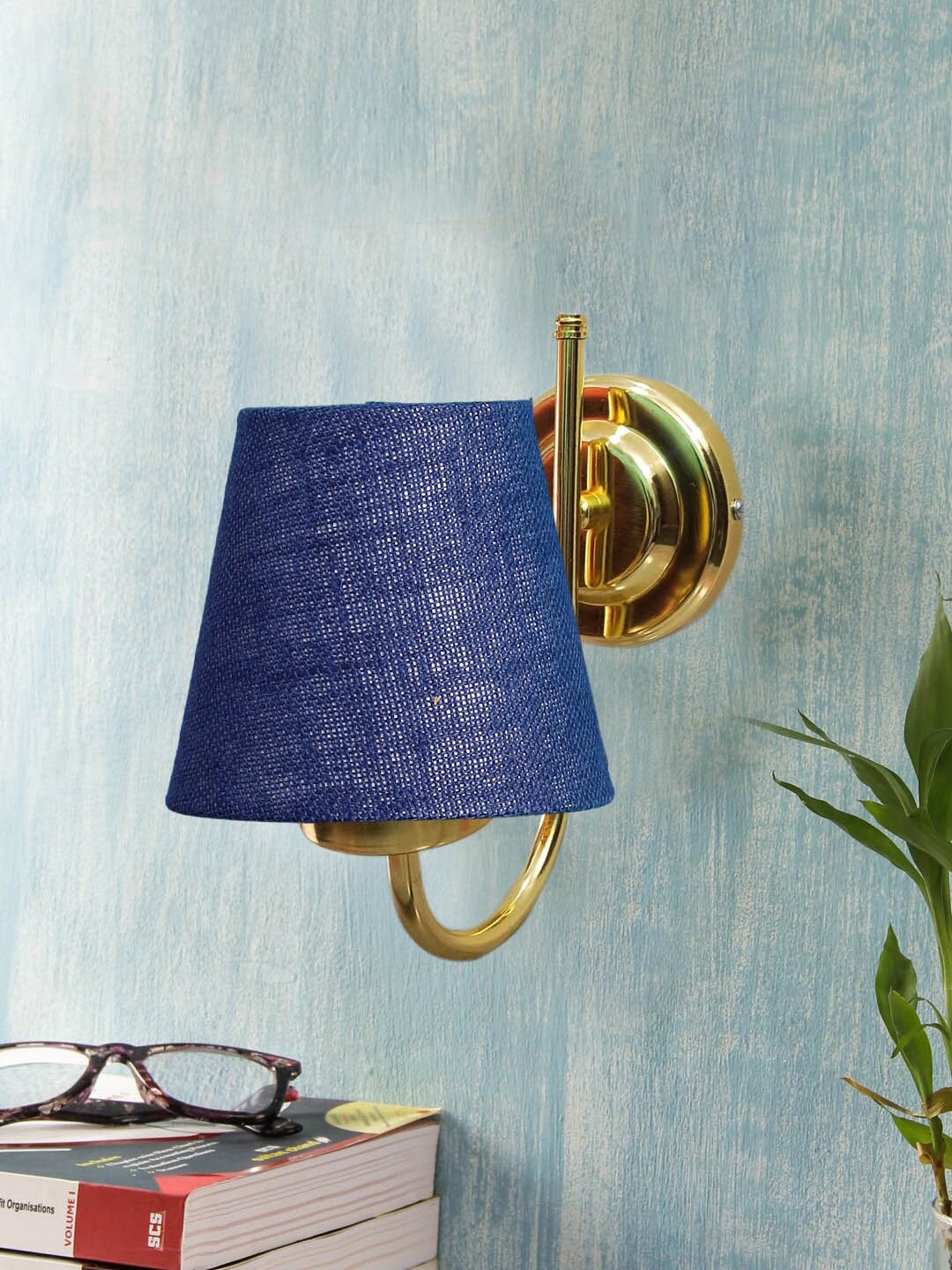 

Devansh Blue & Gold Toned Textured Frustum Shaped Jute Wall Lamp