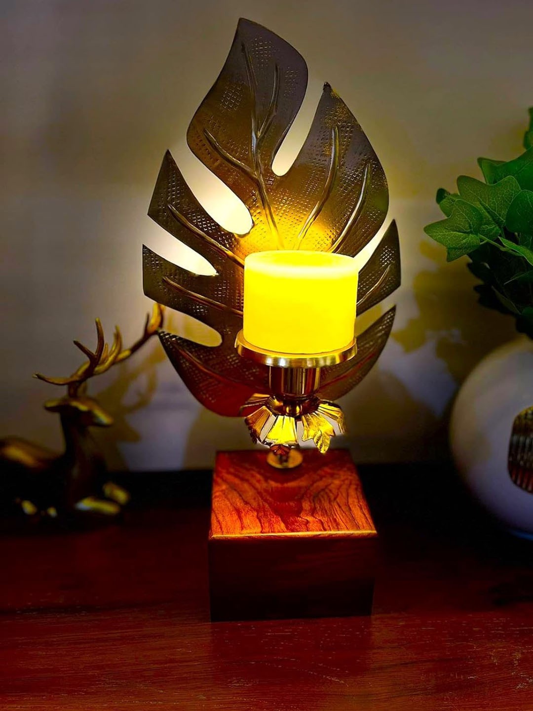 

The Artage Gold Toned Leaf Candle Stand Showpiece