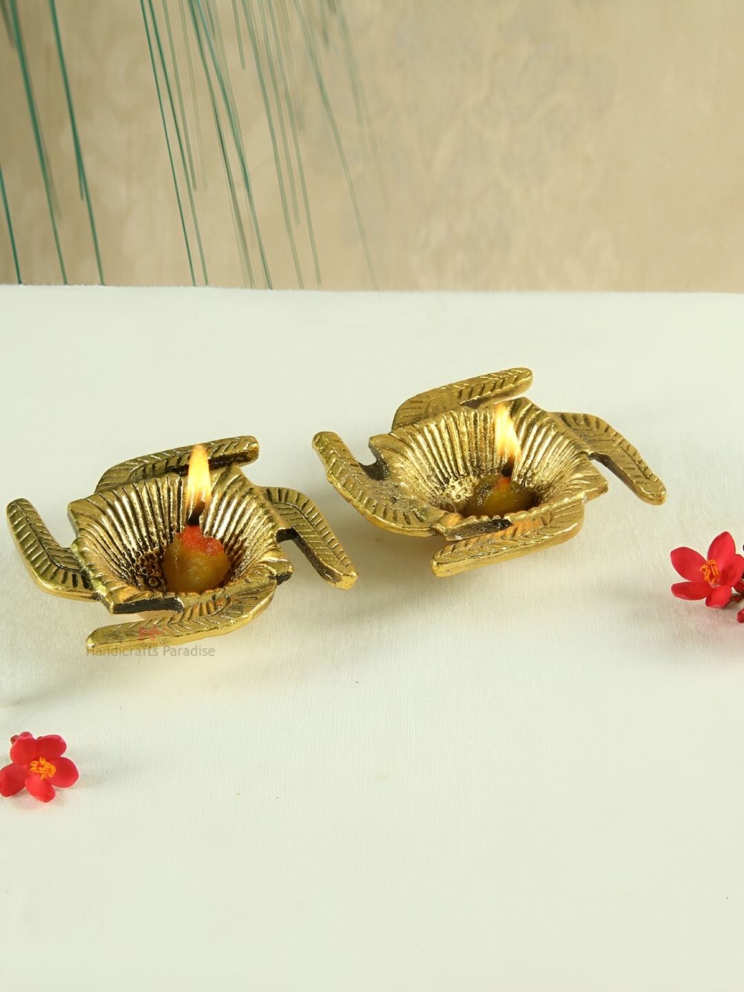 

HANDICRAFTS PARADISE Gold Toned 2 Pcs Beige Swastik Designed Antique Metal Pooja Diyas