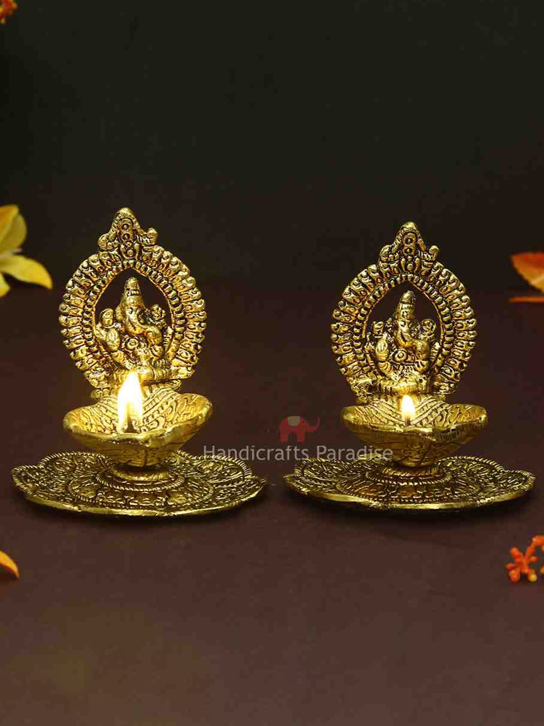 

HANDICRAFTS PARADISE Gold Toned 2 Pcs Ganesh Diyas With Swastik Engraved