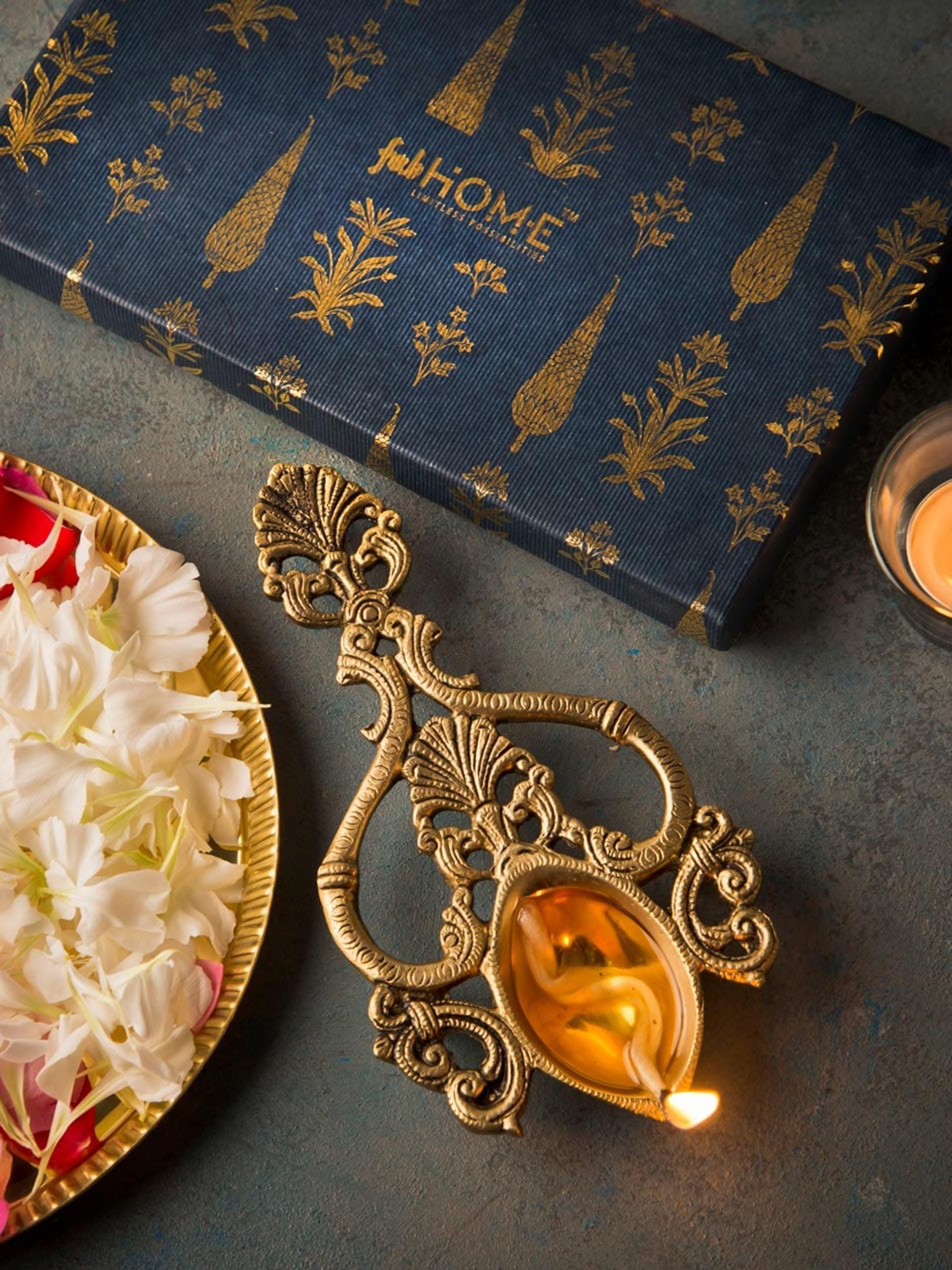 

Fabindia Gold Toend Flower Shaped Metal Pooja Diya