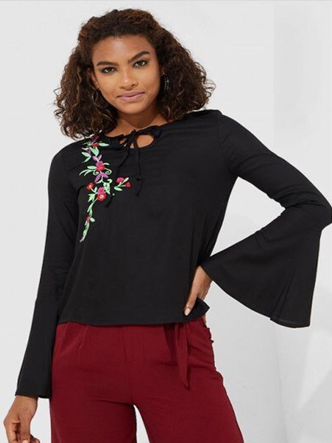 

Aila Floral Printed Tie Up Neck Bell Sleeves Cotton Top, Black