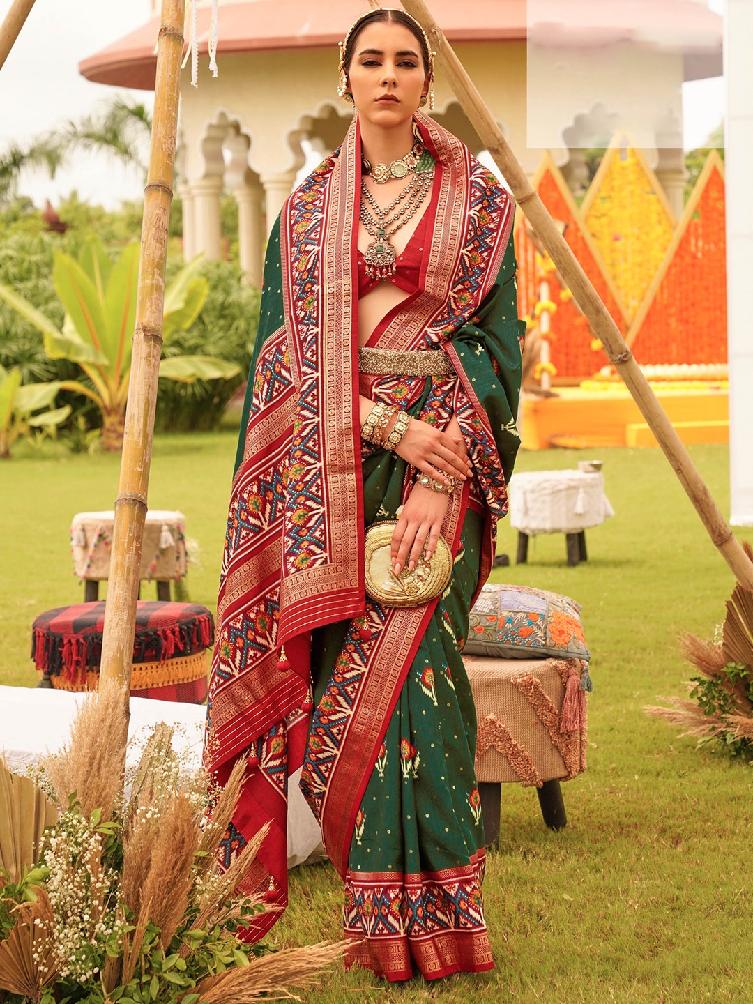 

Mitera Green Ethnic Motifs Printed Patola Saree