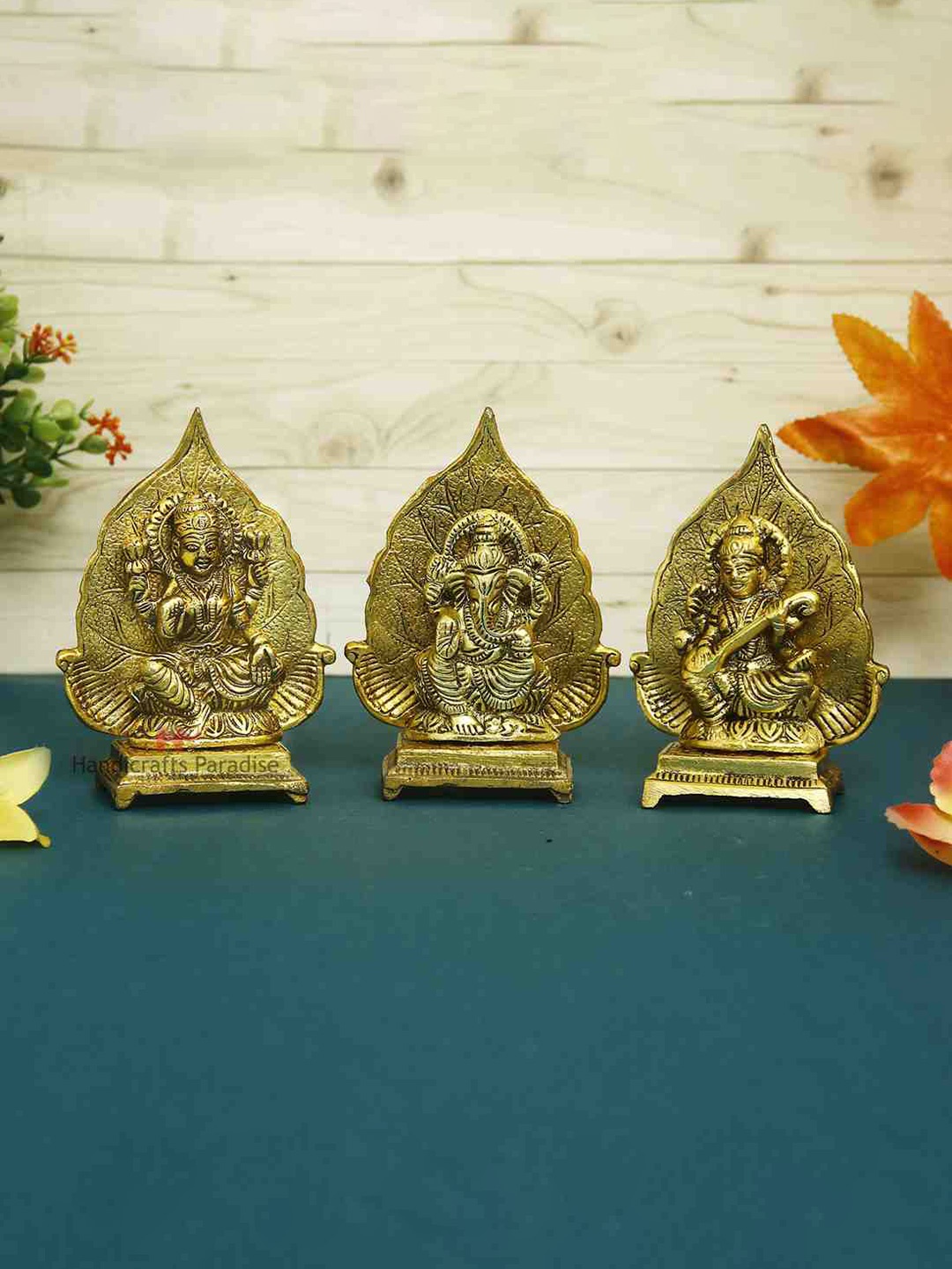 

HANDICRAFTS PARADISE Gold-Toned Lakshmi ji Ganesh ji and saraswati ji Metal Showpiece