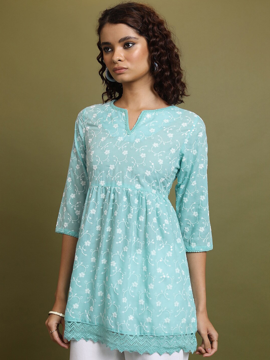 

Vishudh Turquoise Blue & White Floral Embroidered Round Notched Neck Pleated A-Line Kurti