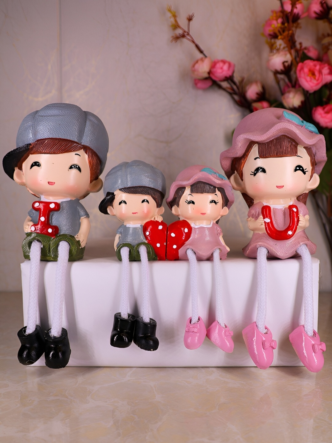 

Elegant Lifestyle Pink & Grey Hanging Leg Family Figurine Showpiece