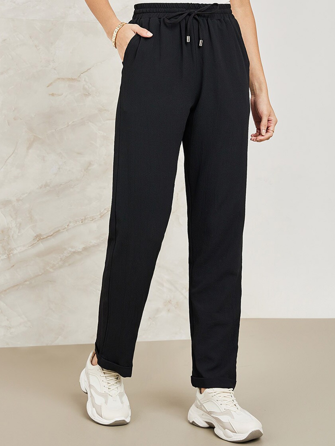 

Styli Black Women Mid-Rise Tapered Fit Trousers