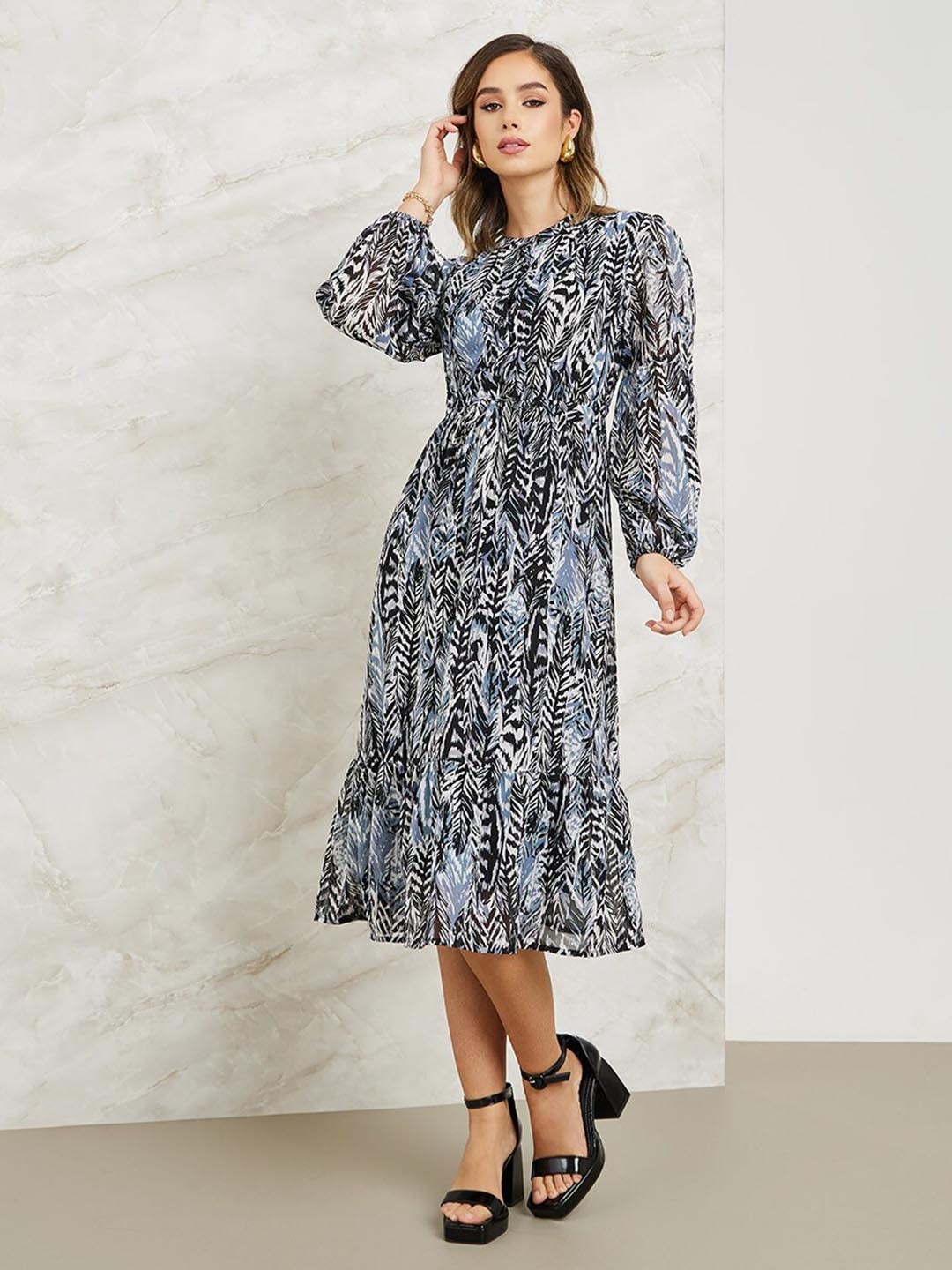 

Styli Blue Abstract Printed Puff Sleeves Tie Ups A-Line Midi Dress