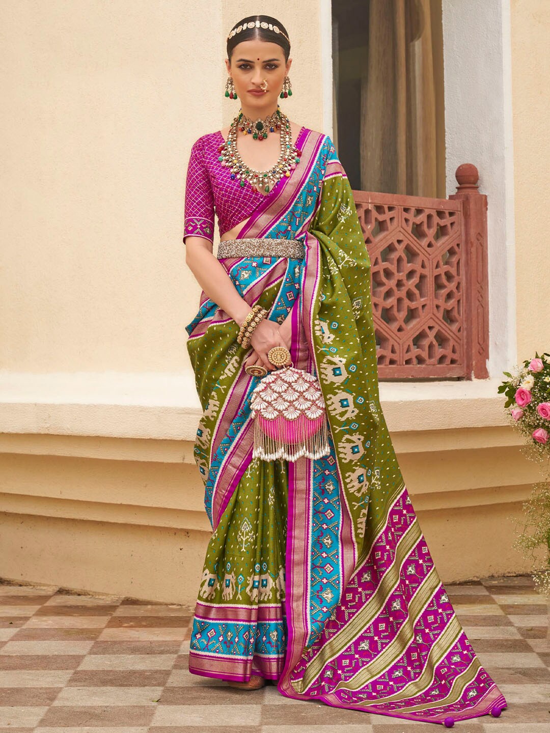 

Anouk Olive Green Ethnic Motifs Printed Zari Patola Saree