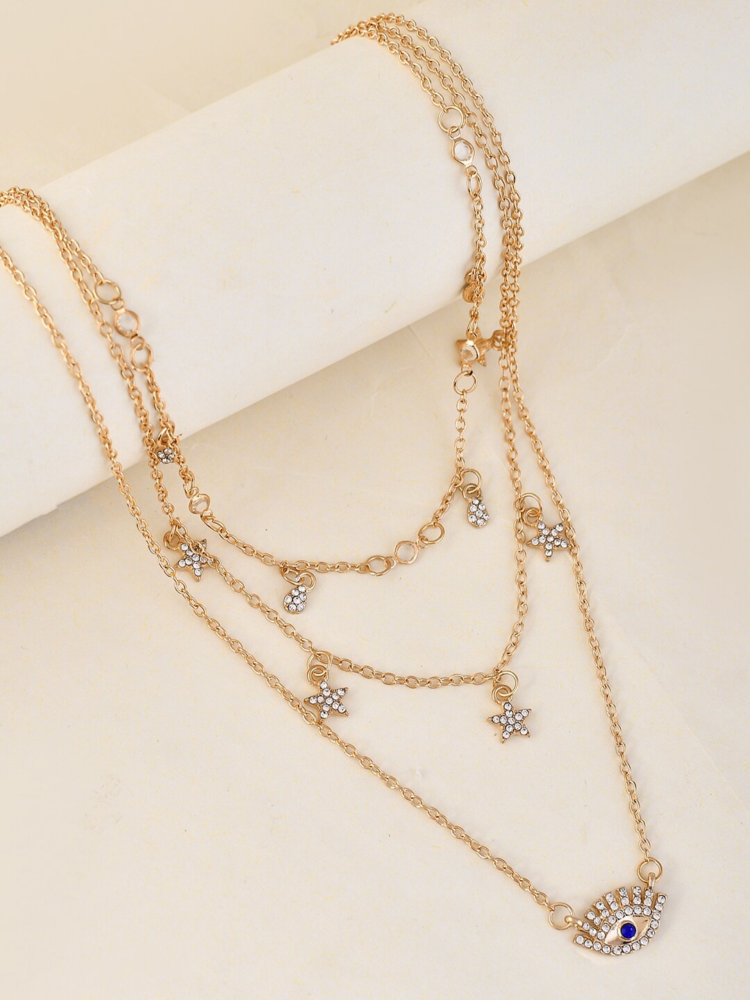 

Voylla Brass Evil Eye Talisman And Twinkling Stars Charm Layered Gold-Plated Necklace