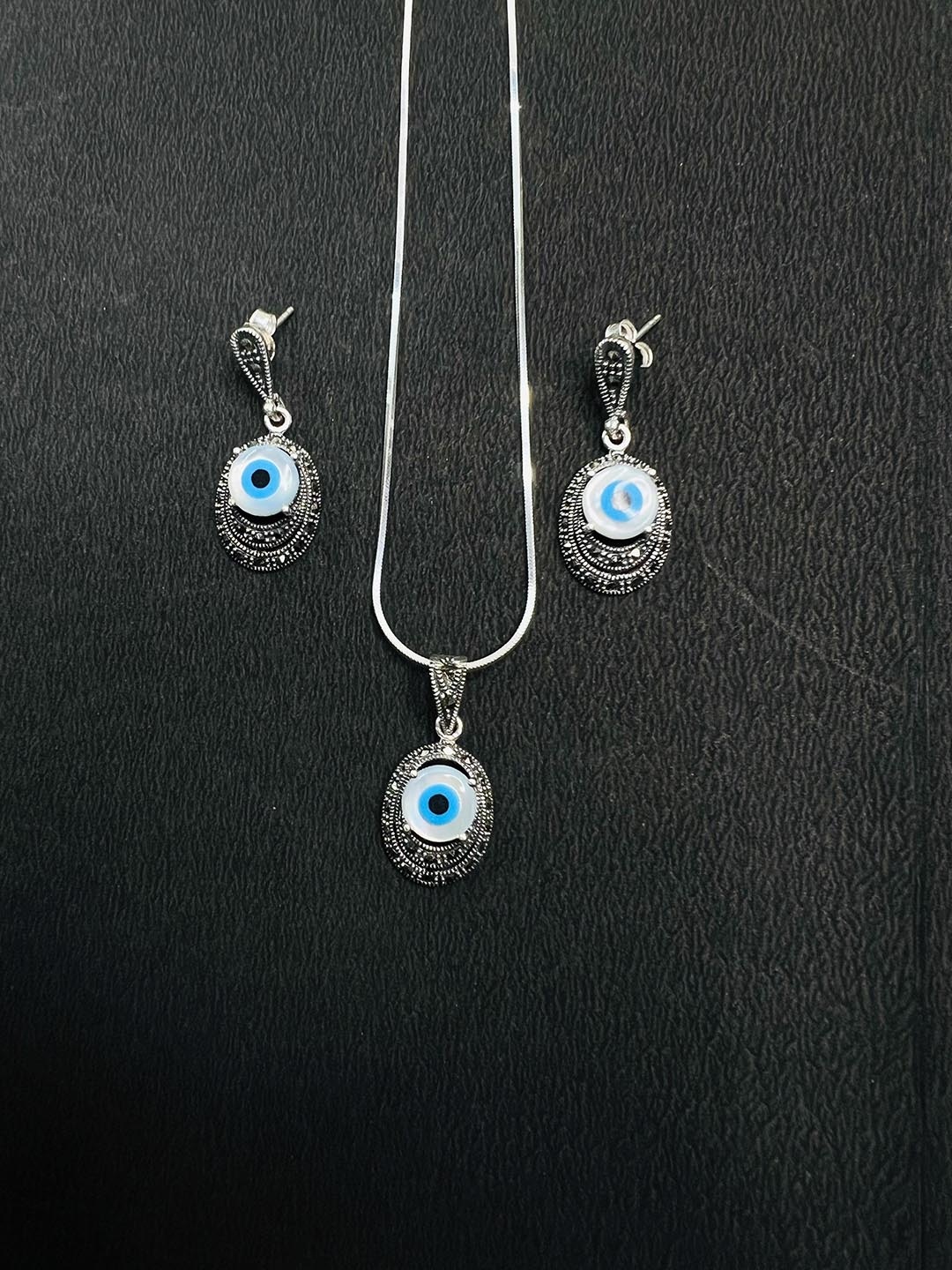 

Arte Jewels Pendant and Earrings, Silver