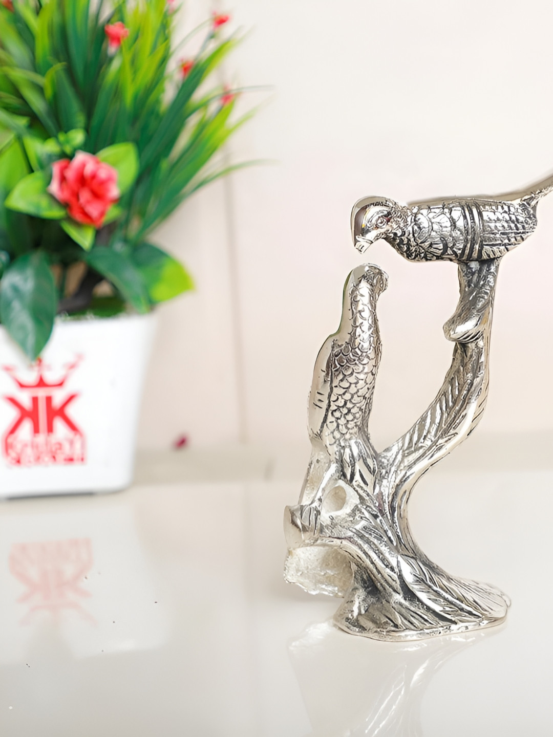 

Kridaykraft Silver-Toned Metal Small Love Birds Kissing On Tree Statue Showpiece
