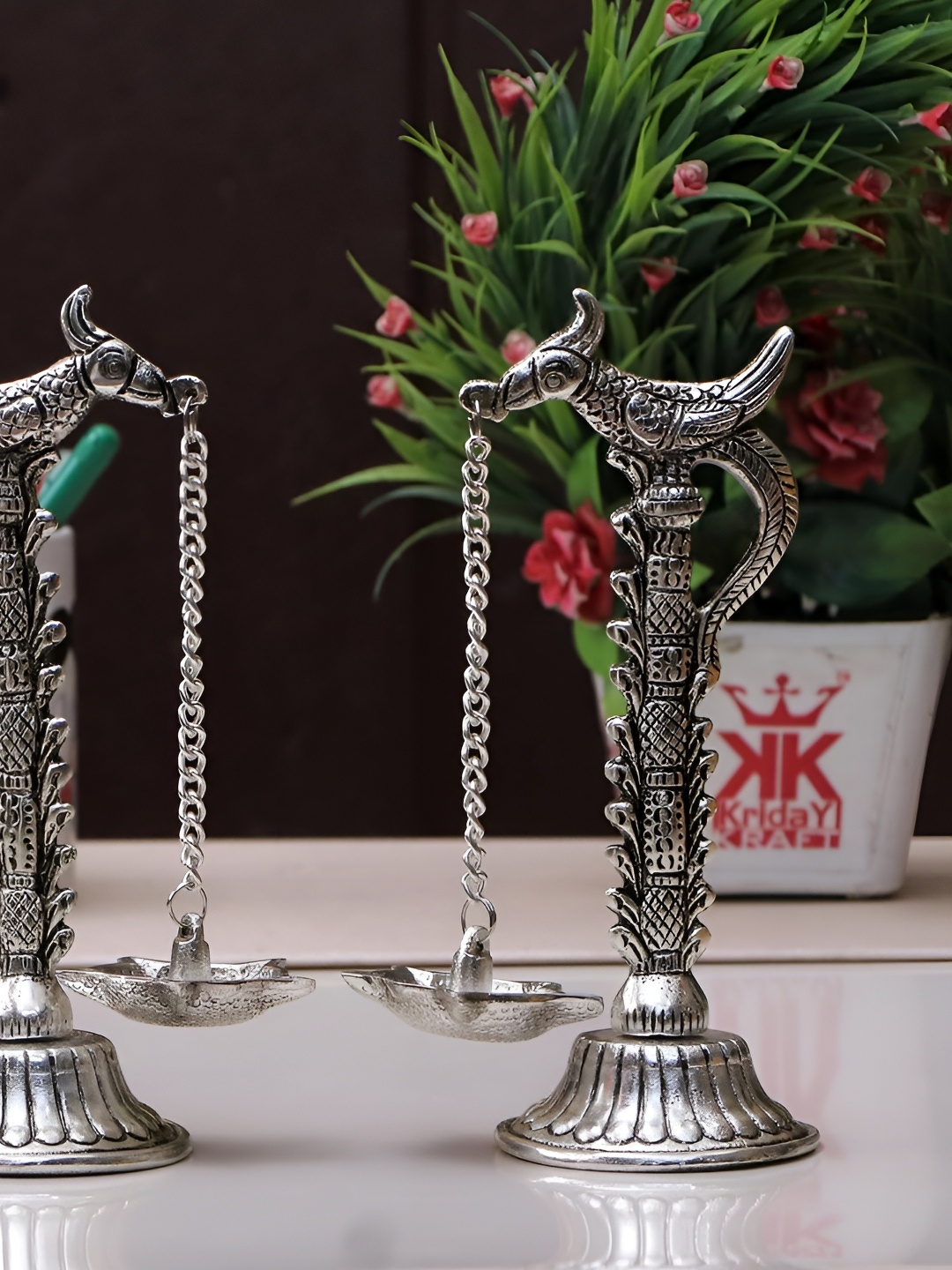 

Kridaykraft Silver Toned 2 Pieces Peacock Beak Hanging Diyas