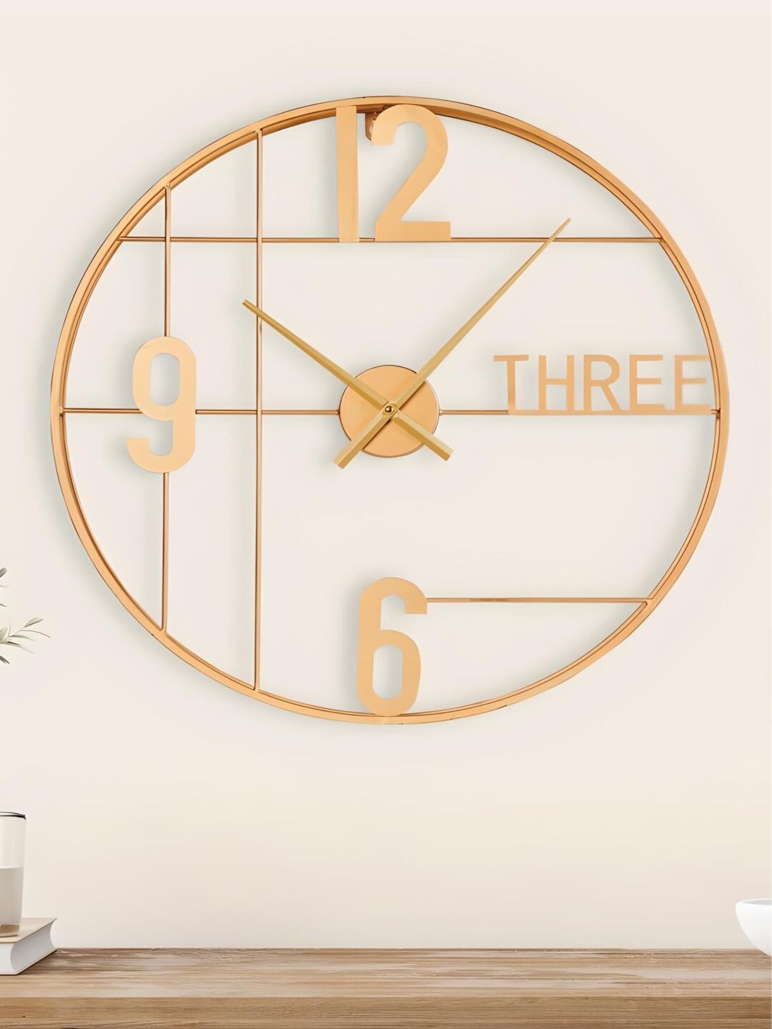 

The Art House Gold-Toned Round Shaped Metal Wall Clock